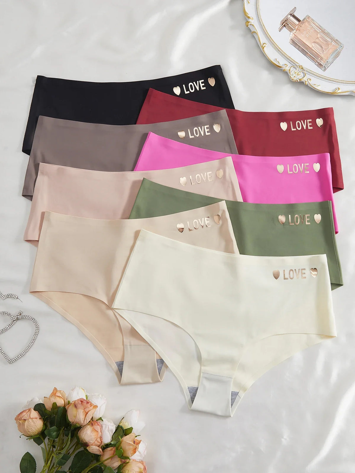 Set of women's underwear in various colors with 'LOVE' print on a light background.