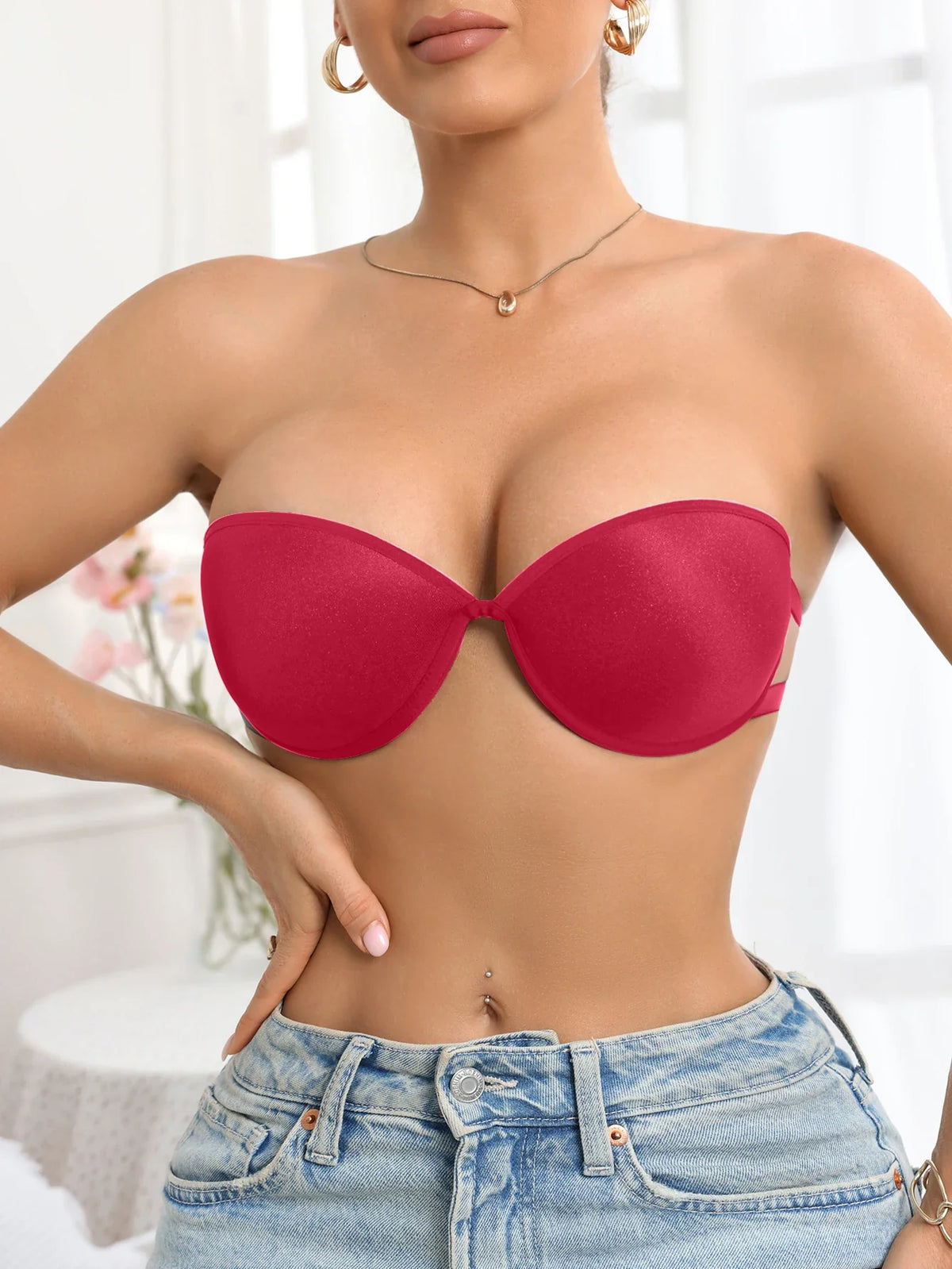 Red strapless bra worn by a person with a blurred background