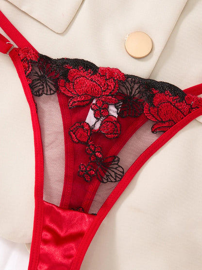 Red and black lace lingerie set on a white background