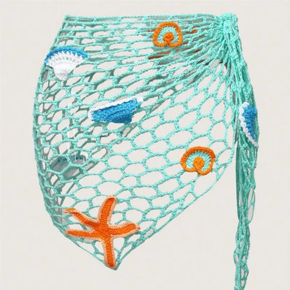 Net bag with crochet accents featuring starfish and seashell patterns on a light background