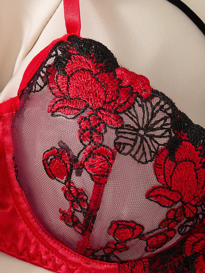 Red and black floral embroidered bralette on a neutral background