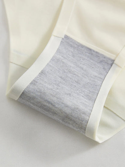 Close-up of a white fabric with a gray textured pocket on a light background