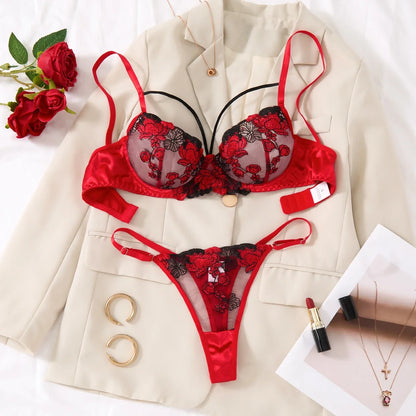 Red and black floral lingerie set on a beige blazer with accessories.