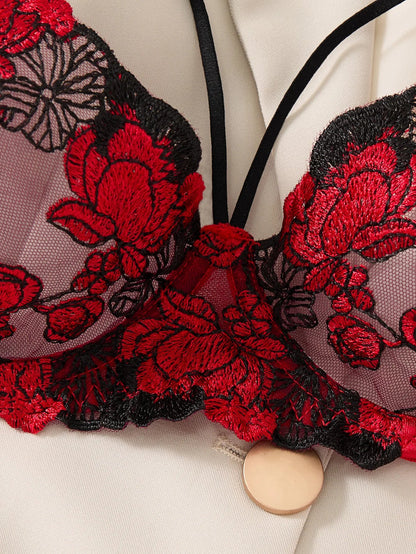 Close-up of a red and black floral embroidered garment on a white background