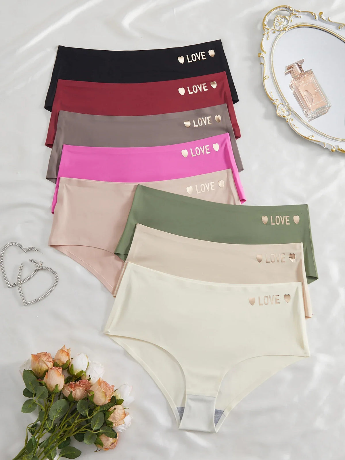 Set of women's underwear in various colors with 'LOVE' and heart designs on a light background.