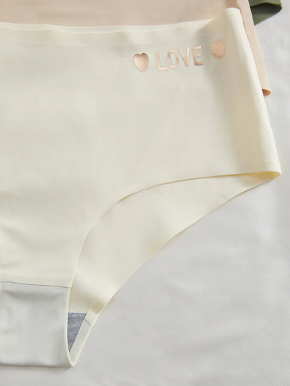 Beige underwear with 'LOVE' and heart designs on a light gray background