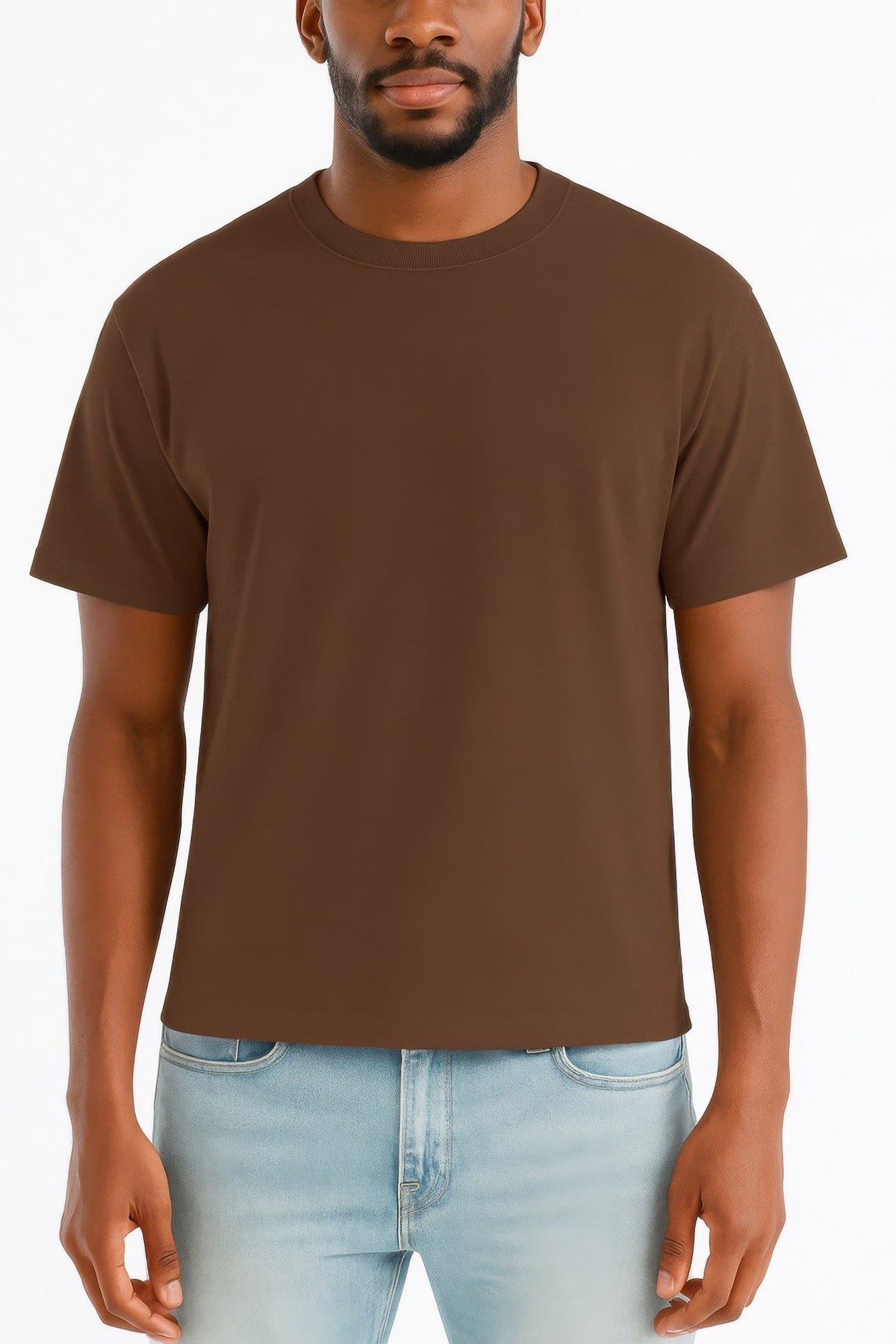 Man wearing a brown t-shirt and light blue jeans on a white background