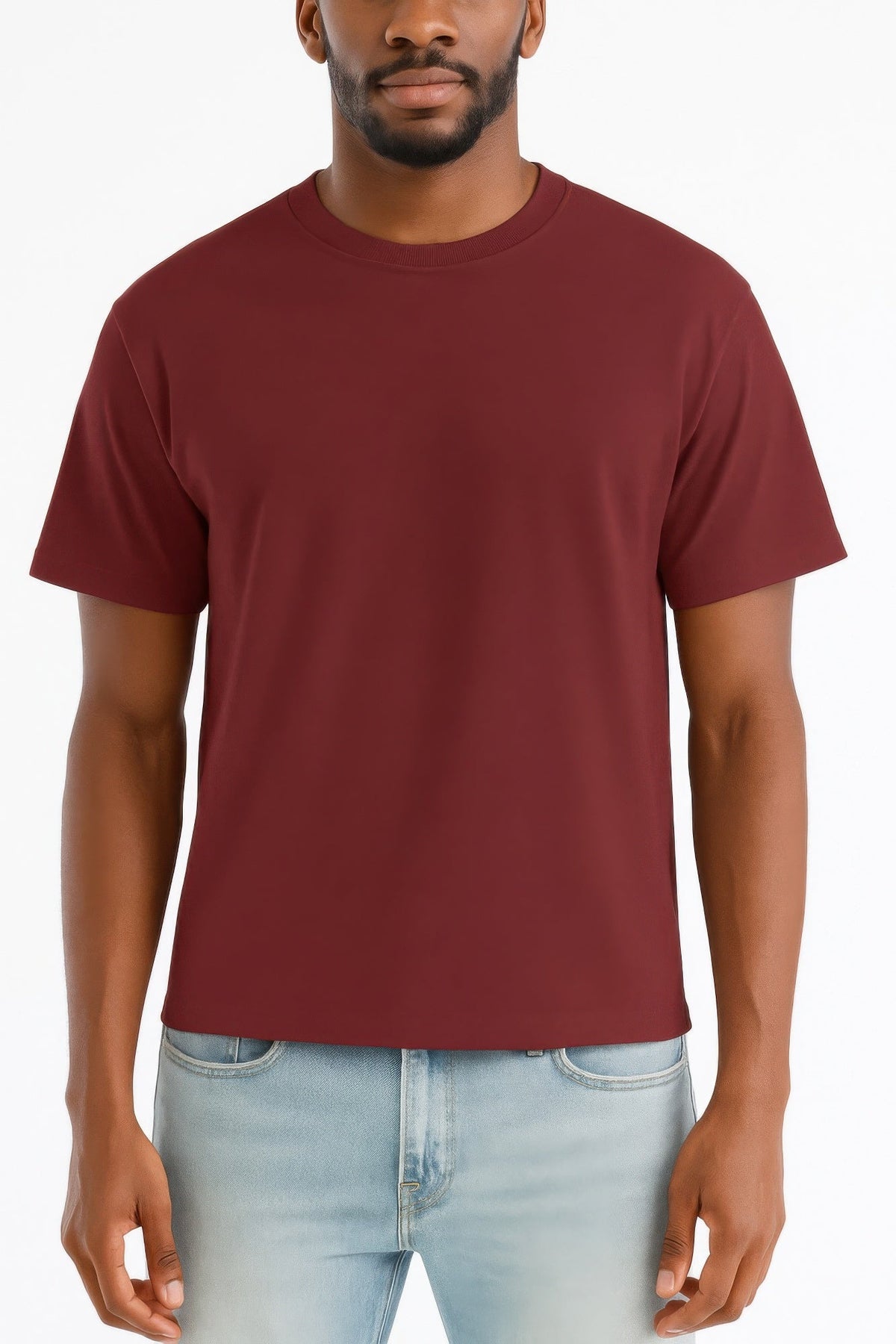 A man wearing a solid maroon crew-neck t-shirt and light blue jeans, shown from the chin down against a plain white background.