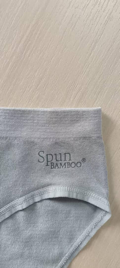 Gray bamboo underwear on a light wood surface with 'Spun Bamboo' branding.