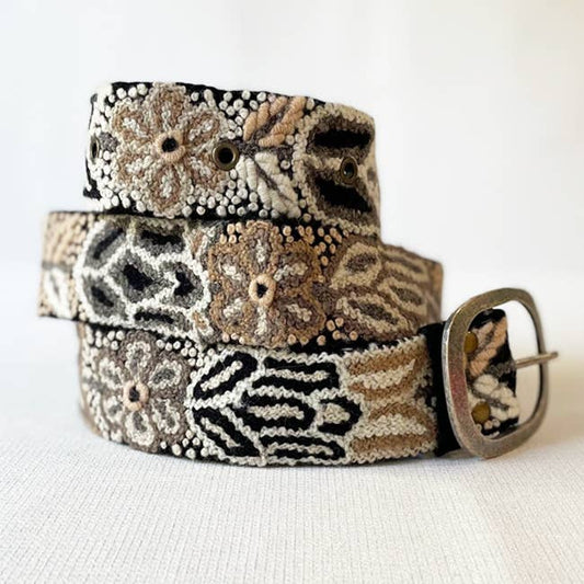 Decorative belt with a patterned design on a white background