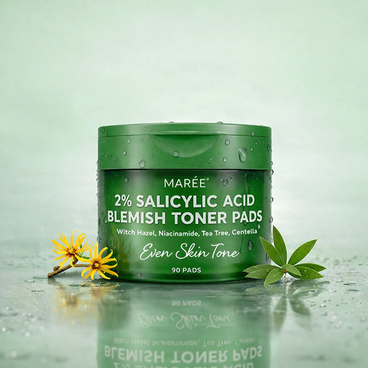 Green container of Maré 2% Salicylic Acid Blemish Toner Pads on a light green background with leaves and flowers.