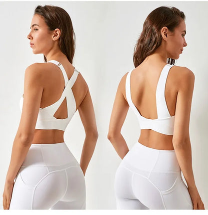 Woman wearing a white sports bra and leggings from front and back views on a light gray background