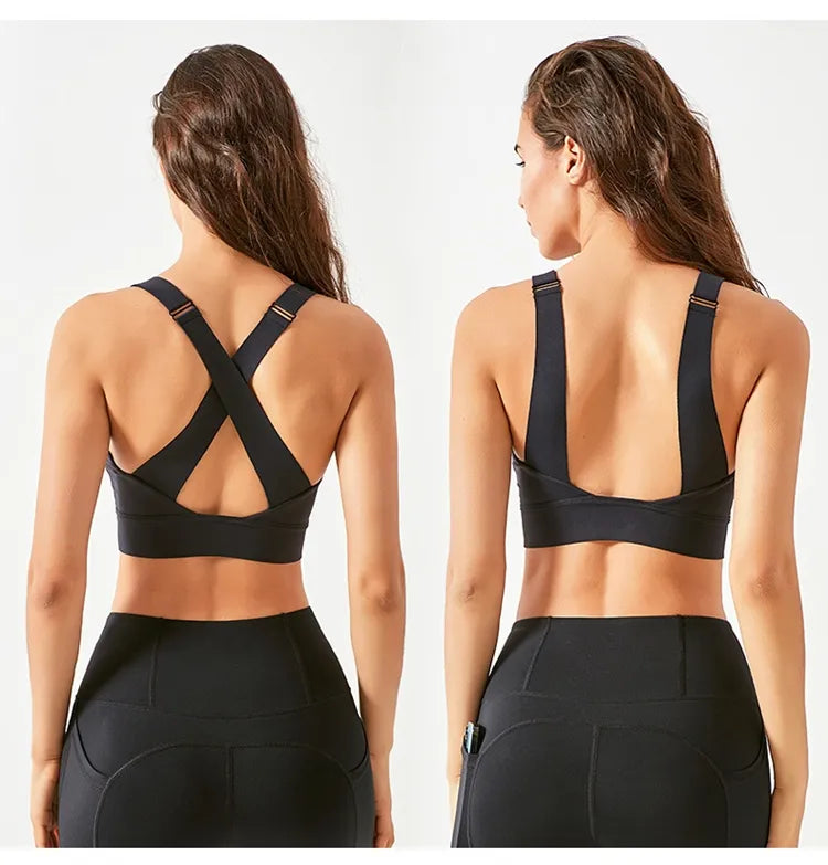 Black sports bra and leggings worn by a model on a white background