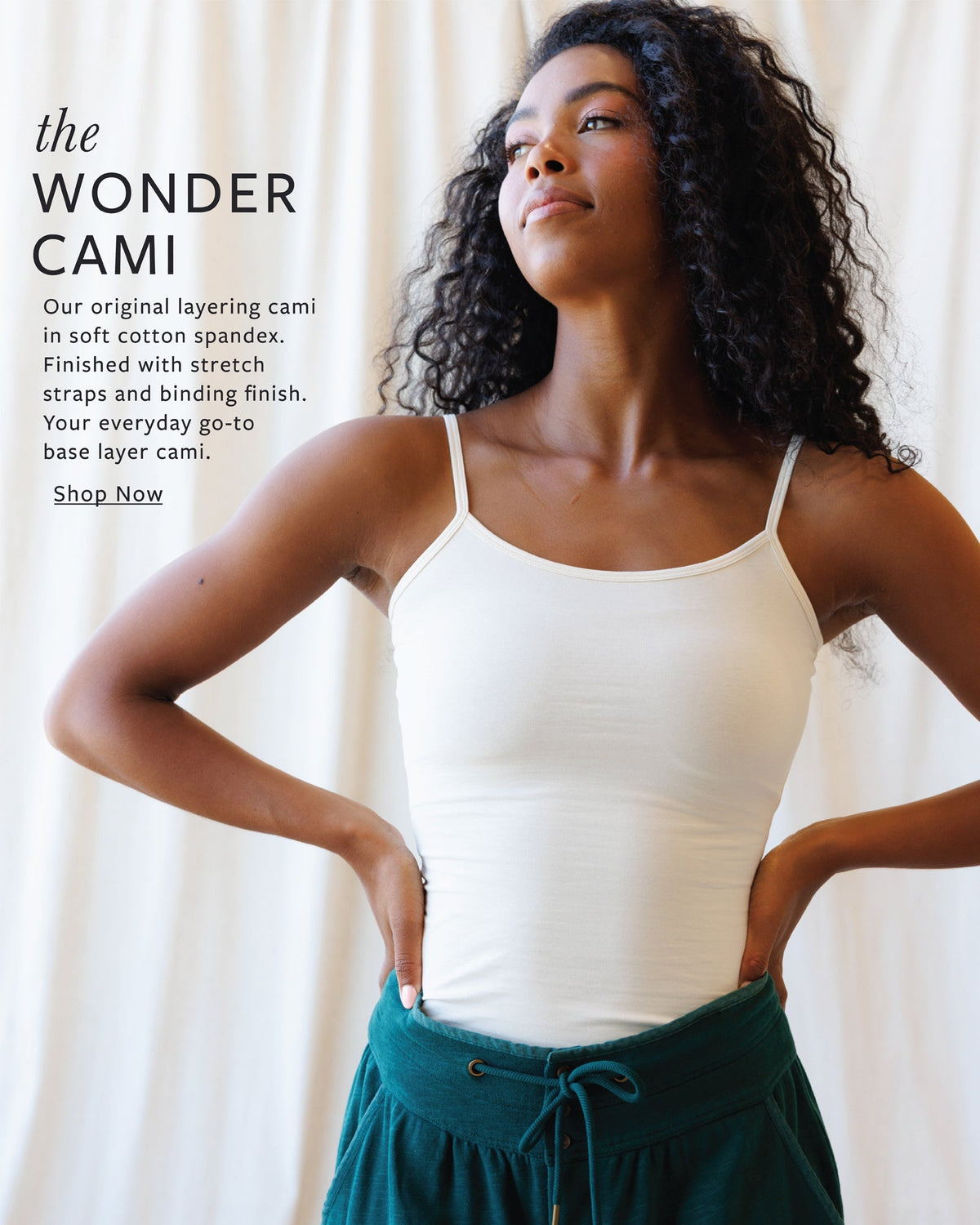 Woman wearing a white tank top with text about the 'Wonder Cami' on a light background