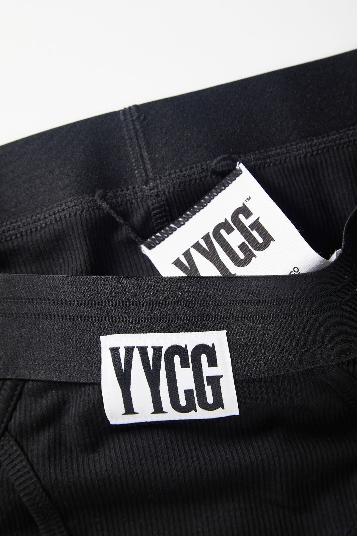 Black pants with YYCG logo and text on a white background