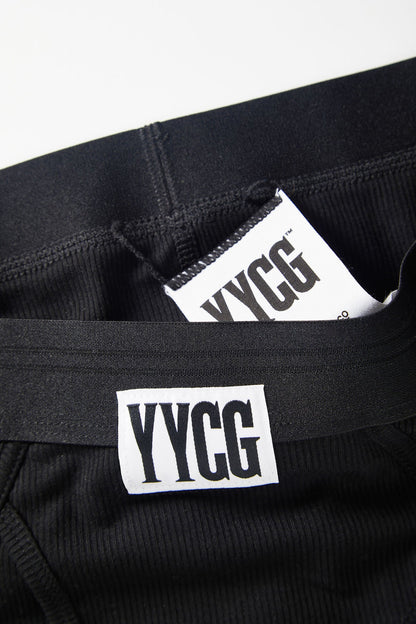 Black pants with YYCG logo and text on a white background