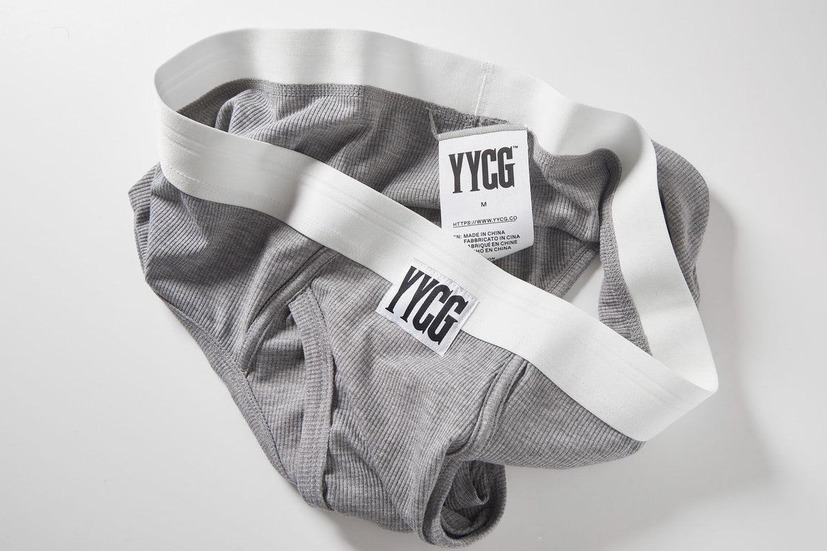 Gray underwear with white waistband and 'YYCG' label on a light gray background