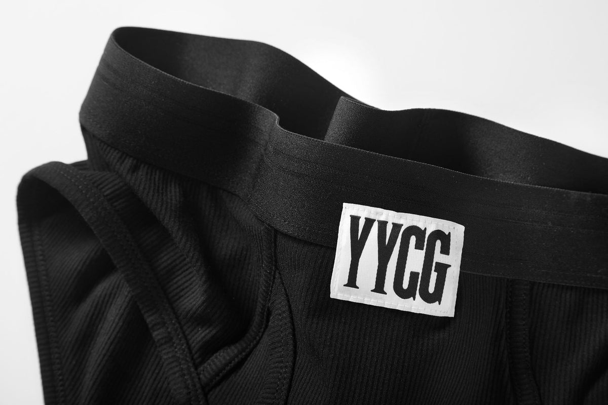 Black garment with 'YYG' label on a white background