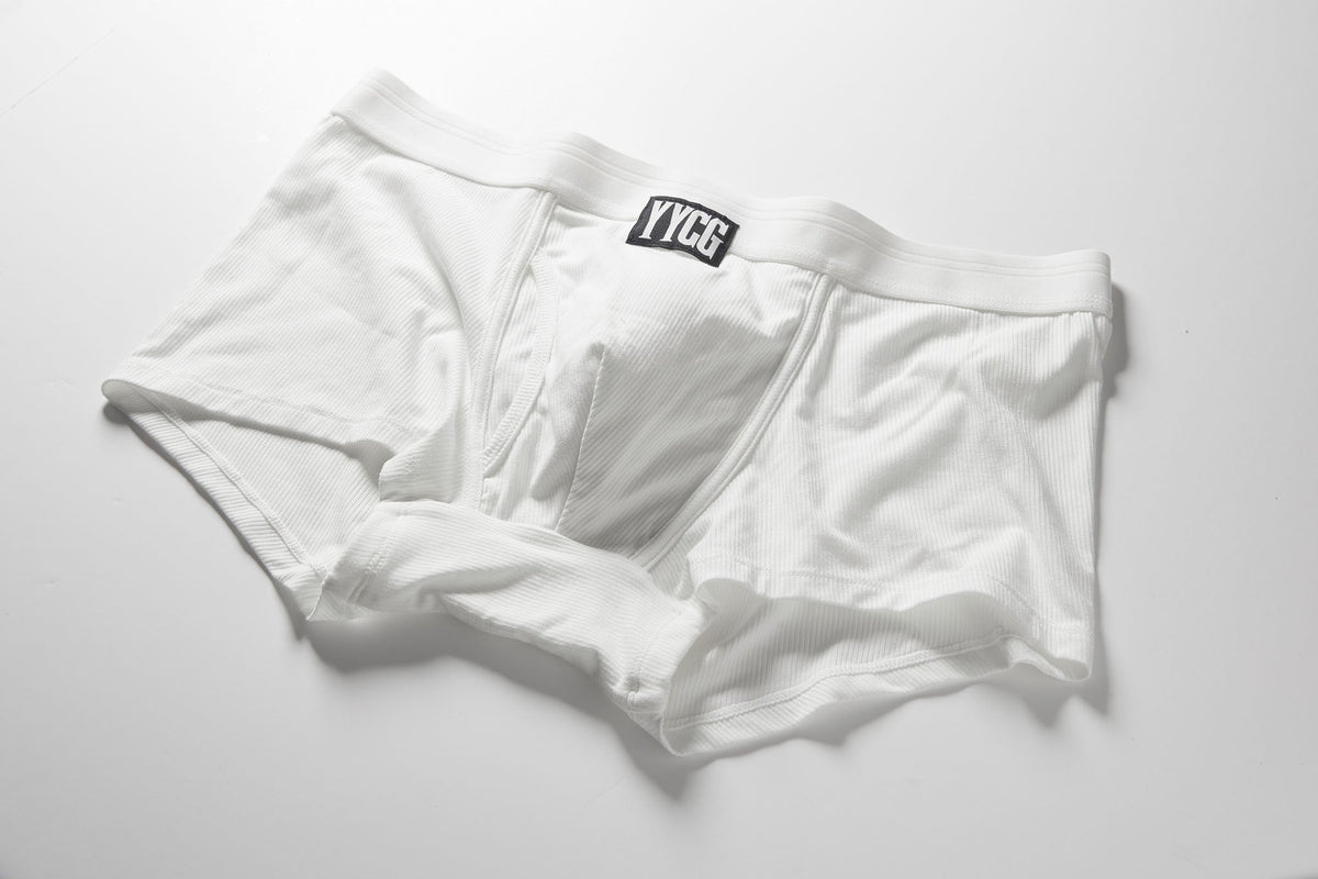 White boxer briefs with a brand label on a light gray background
