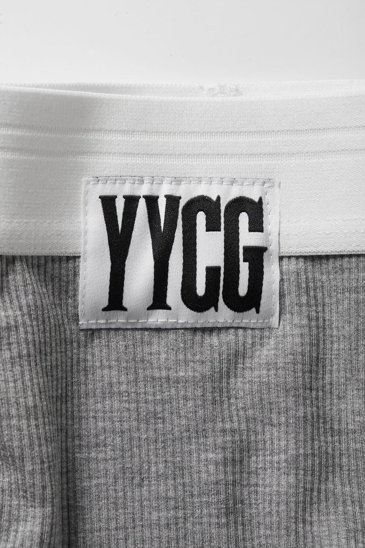Label with 'YYGG' text on a textured fabric background
