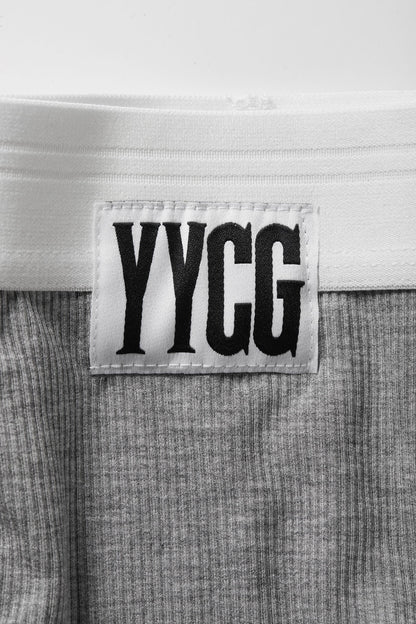 Label with 'YYGG' text on a textured fabric background