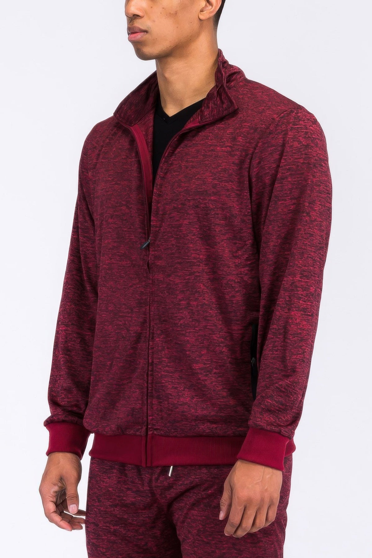 Maroon tracksuit worn by a person on a white background