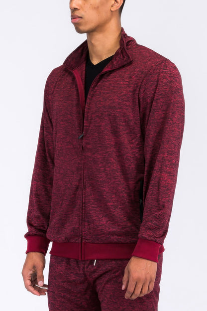 Maroon tracksuit worn by a person on a white background