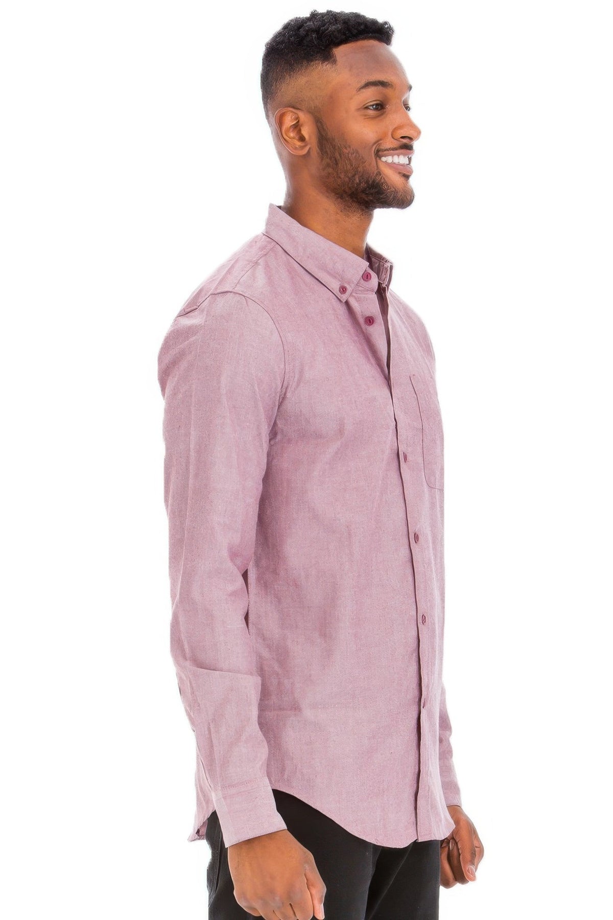 Man wearing a light pink button-up shirt on a white background