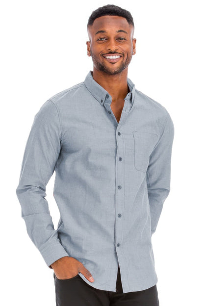 Man wearing a light blue button-up shirt on a white background