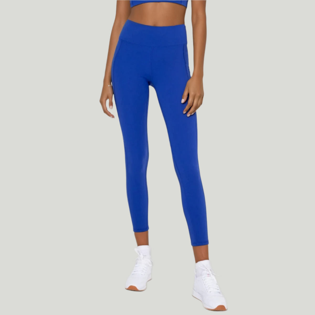 Power Flow Cropped Leggings with Pockets in Blue, studio photo