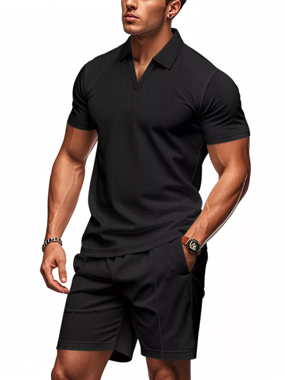 Man wearing a black textured polo shirt and shorts on a white background