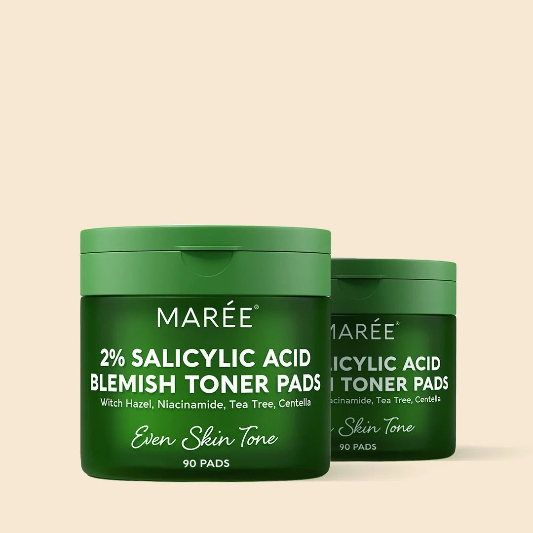 Two green containers of Marée 2% Salicylic Acid Blemish Toner Pads on a beige background