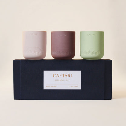 Caftari Signature Candle Gift Set: three ceramic candles beside a black Caftari gift box