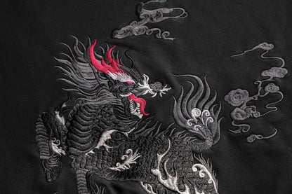 Embroidered dragon design on a dark fabric background