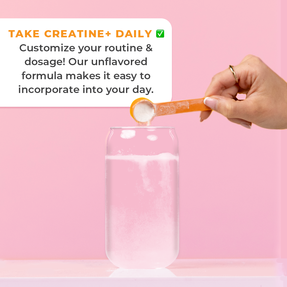 Hand holding a creatine powder scoop over a glass of water with promotional text on a pink background