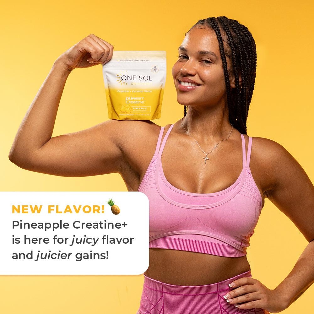 A woman in a pink sports bra and matching leggings flexes while holding up a yellow and white One Sol supplement pouch labeled Pineapple Creatine+. A white text box on the left says 'NEW FLAVOR! Pineapple Creatine+ is here for juicy flavor and juicier gains!' against a solid yellow background.