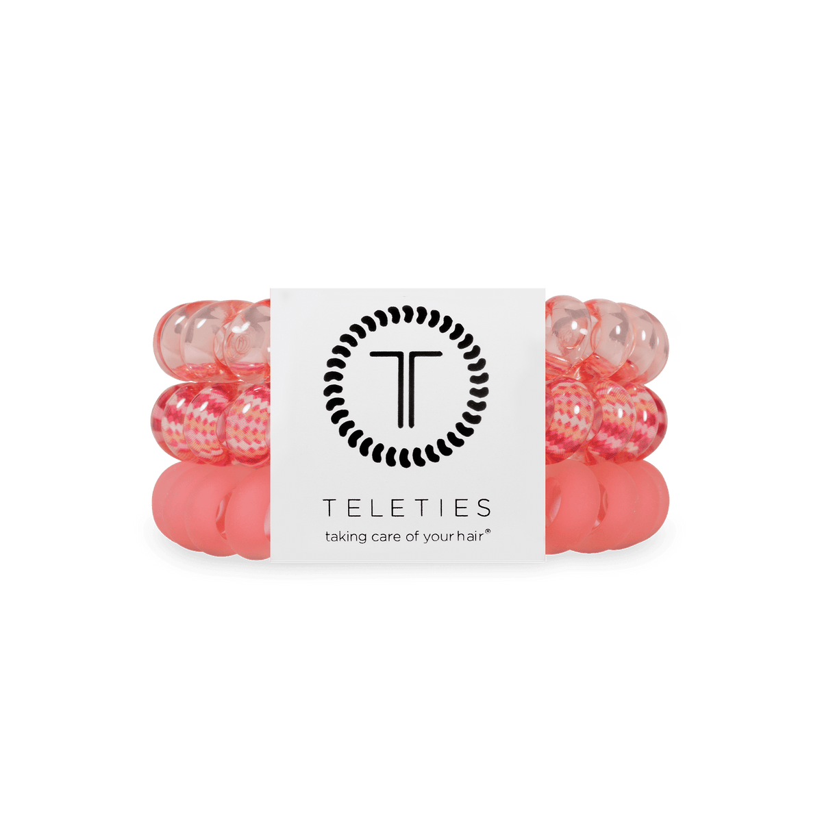 Three pink and translucent hair elastic bands wrapped together with a white paper band featuring the black TELETIES logo and brand name.