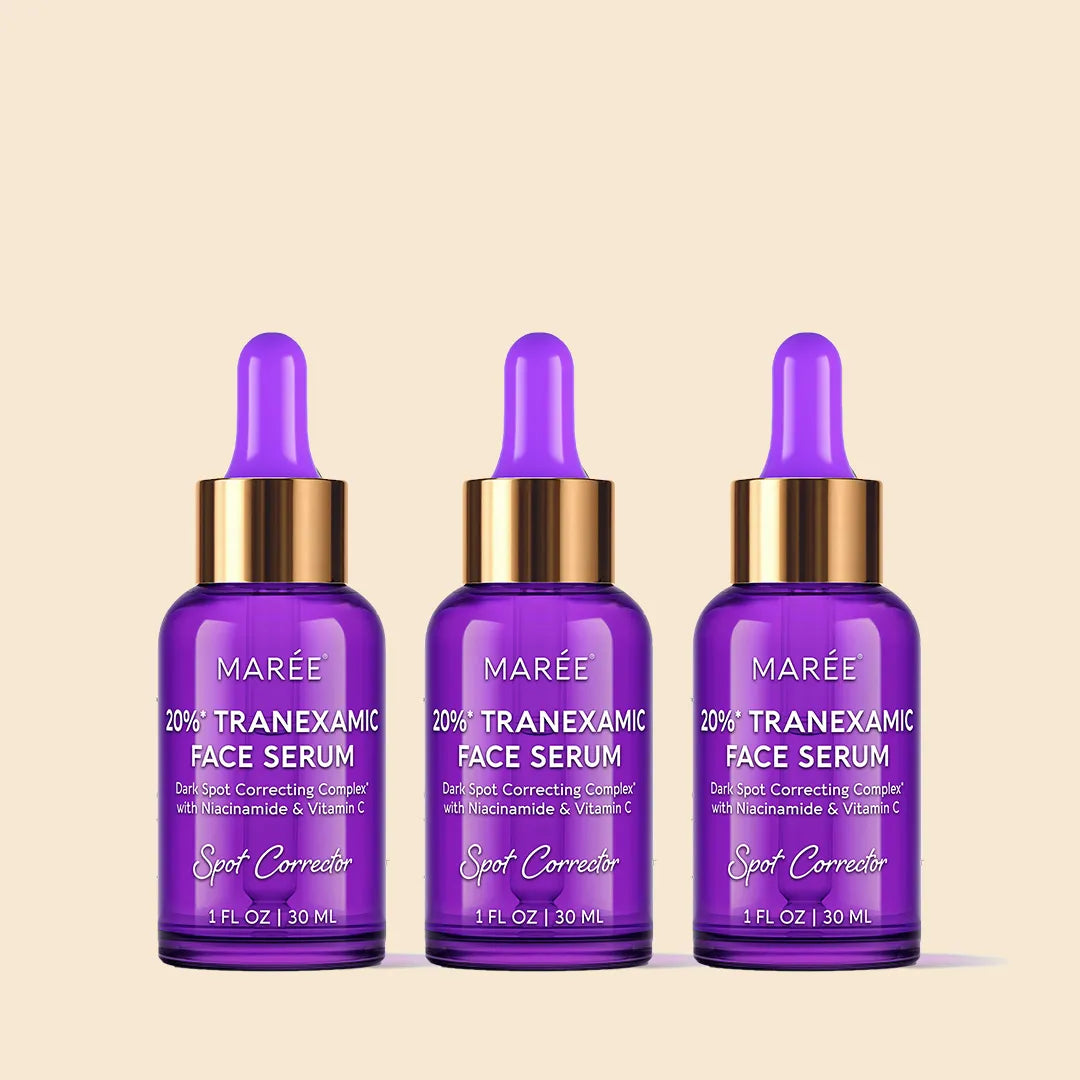 Three bottles of Marée Tranexamic Face Serum on a beige background