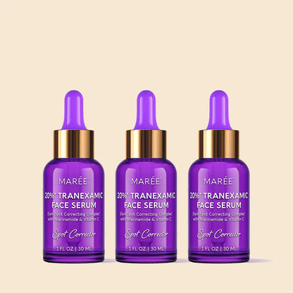 Three bottles of Marée Tranexamic Face Serum on a beige background