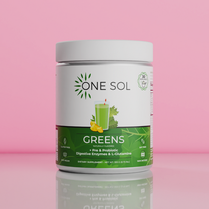 A white plastic jar of One Sol Greens dietary supplement with a green and white label, set against a solid pink background with a soft reflection below.