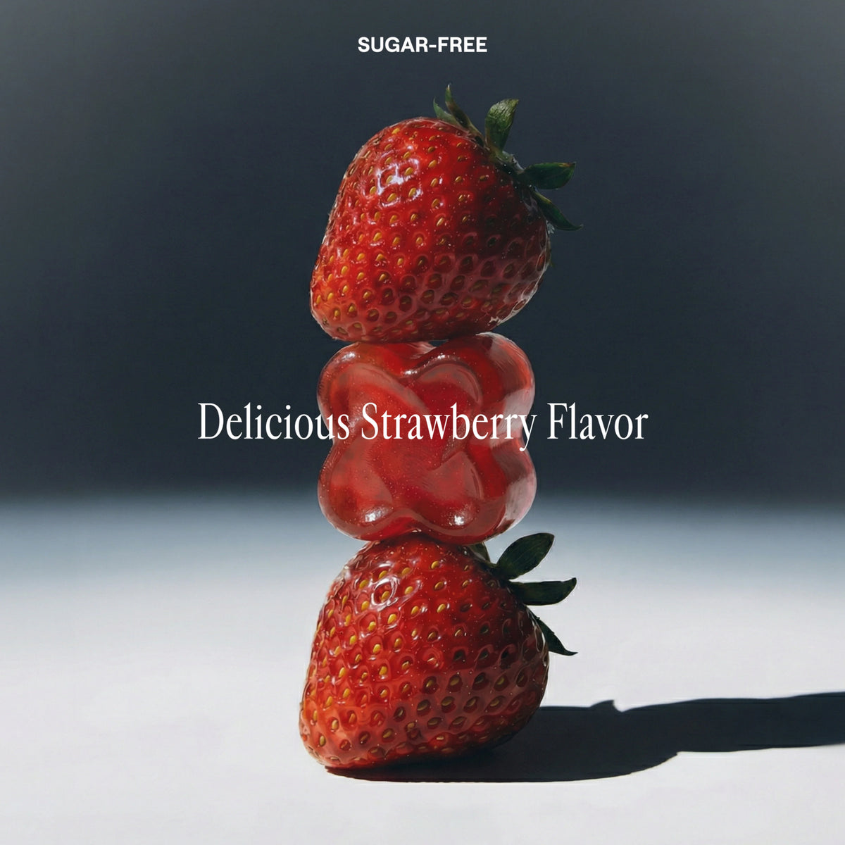 Three stacked strawberries with white text reading 'SUGAR-FREE' at the top and 'Delicious Strawberry Flavor' across the center, set against a dark-to-light gray gradient background.