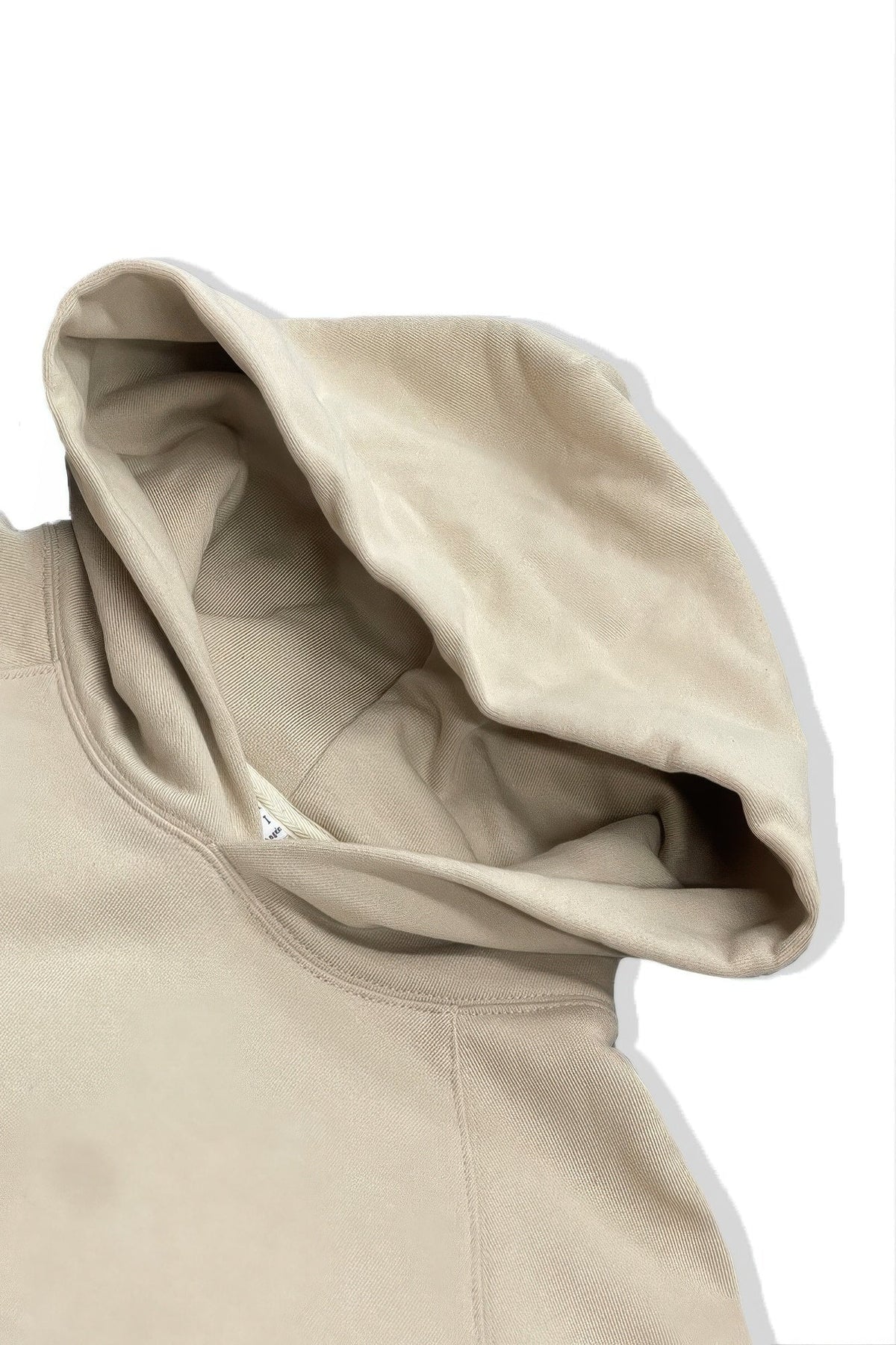 Close-up of a beige hoodie with a white background