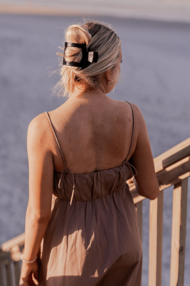 TELETIES Jet Black large flat square hair clip worn on a model, outdoor lifestyle photo