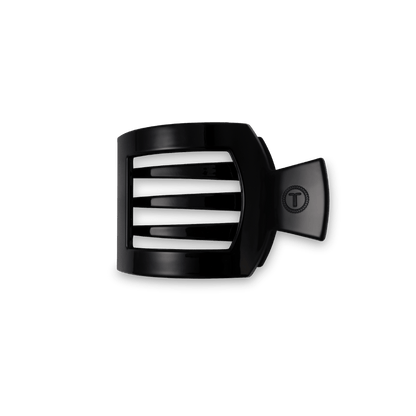 TELETIES Jet Black small flat square hair clip with an embossed T logo, on a dark green background