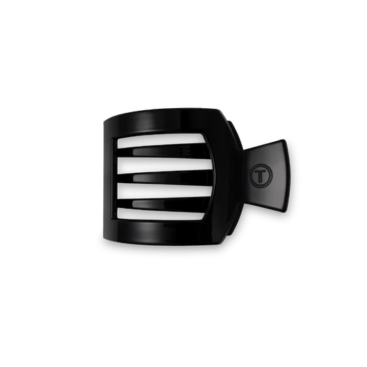 TELETIES Jet Black small flat square hair clip with an embossed T logo, on a dark green background