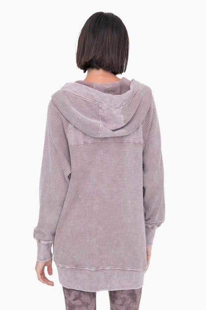 Person wearing a textured hoodie on a white background
