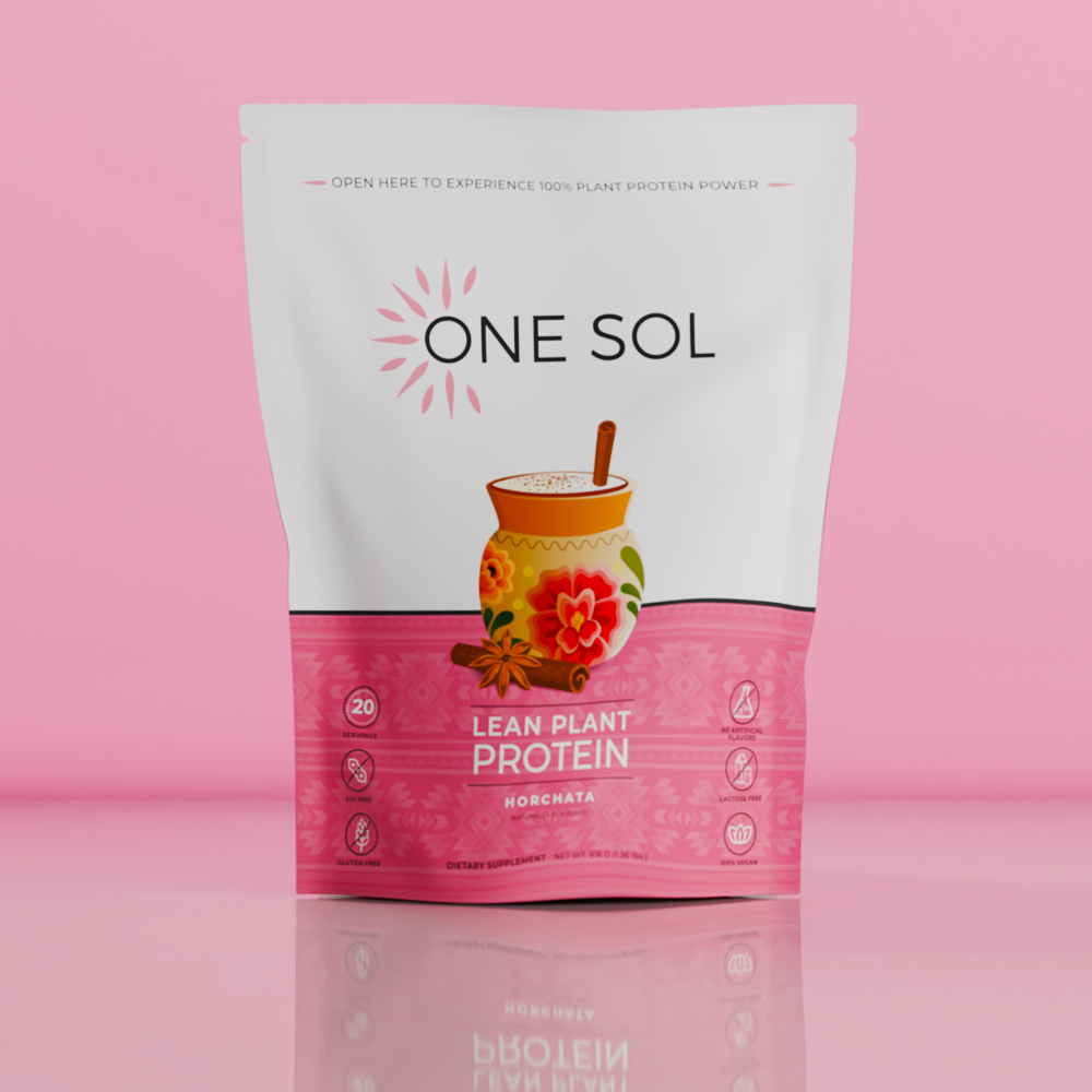 A stand-up pouch of One Sol Lean Plant Protein Roachita on a pink reflective studio background. The package is white on top and bright pink on the bottom, with a central illustration of a jar of roachita and floral graphics.