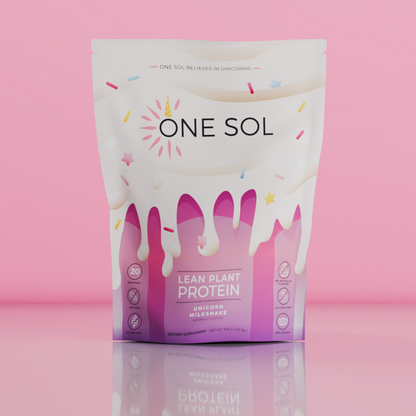 A stand-up pouch of ONE SOL Lean Plant Protein Unicorn Milkshake powder, featuring a white and pink design with dripping milk graphics, set against a solid pink background.