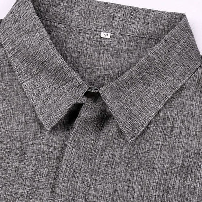 Close-up of a gray textured shirt with collar and brand label.