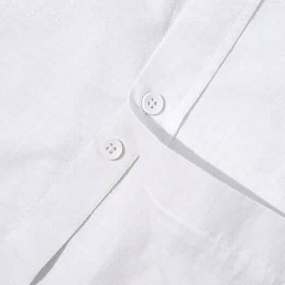 Close-up of a white shirt with button details on a light gray background